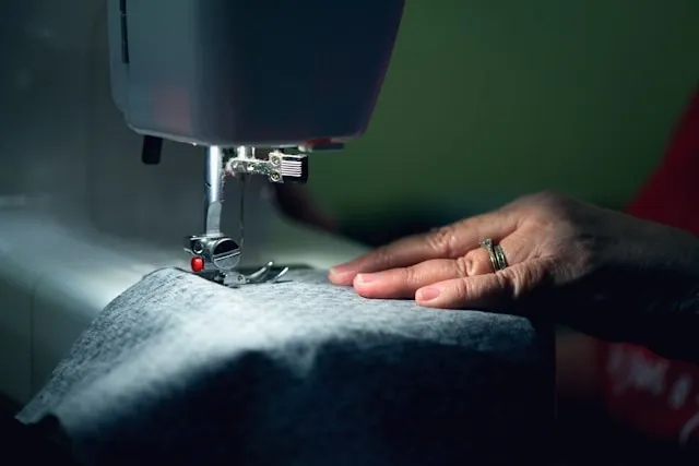 a person using a sewing machine for how to sew a table runner
