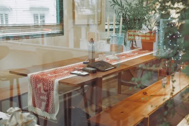 a christmas-themed table runner on a table for how to sew a table runner