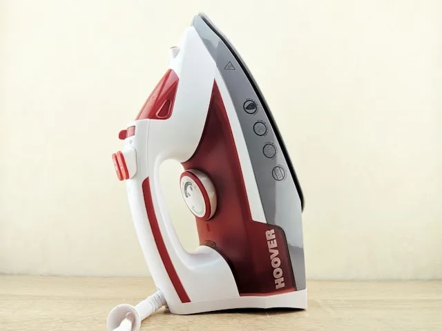 a red and white clothes iron for how to iron on patches with parchment paper