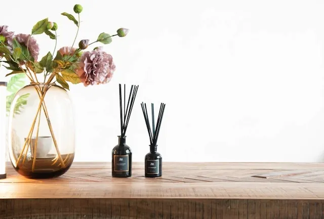 some reed diffusers on a shelf for how to make a diy natural air freshener