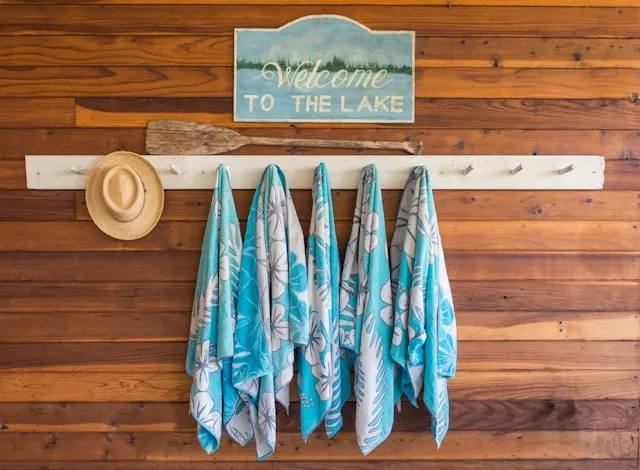 blue towels hanging on a wooden wall for how to soften towels