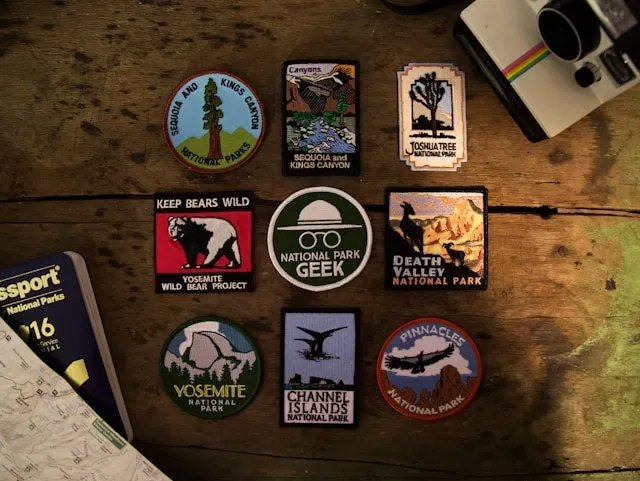 a selection of clothing patches on a wood surface for where to put patches