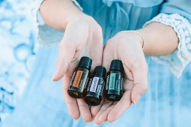 a person holding a selection of essential oils for how to make car air freshener with fragrance oil