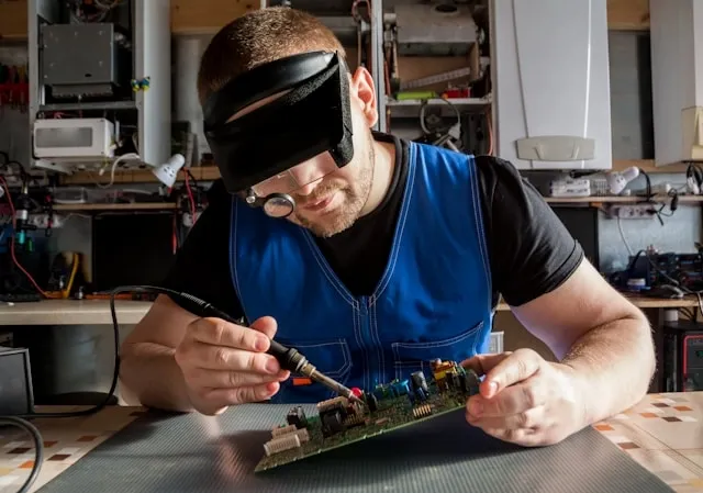 an electrician working on a circuit board for how to fix a neon sign transformer