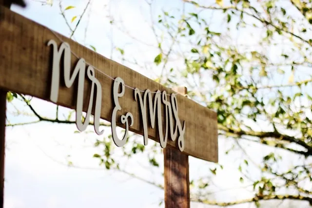 a wooden sign at a wedding for how to hang neon sign wedding