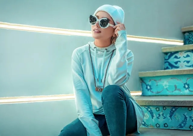 a person sits beside neon lighting for neon light photography