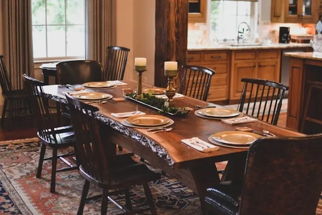 a wooden dining table with place settings for how to protect wood dining table
