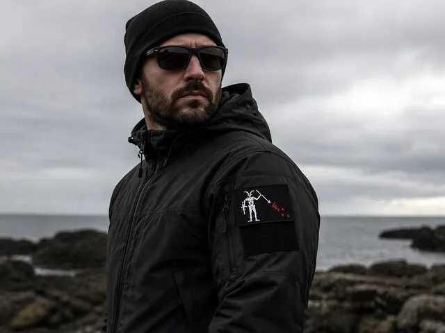 a person wearing a fog patch on a rugged coastline for fog patch military meaning