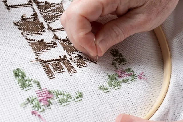 a person practicing embroidery for types of embroidery
