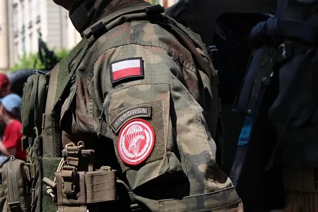 person in tactical gear with patches on their arm for fog patch military meaning
