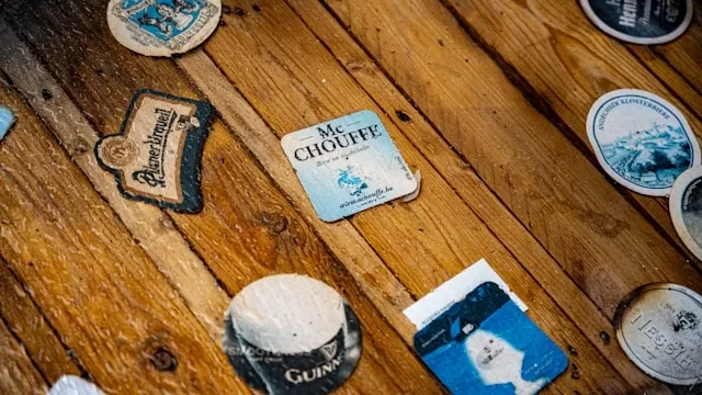 paper beer mats on a wood surface for how to make paper coasters waterproof
