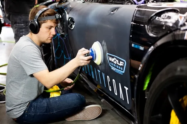 a person adding a topcoat to a vehicle for do car magnets damage paint
