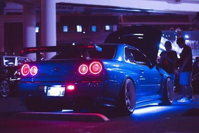 a blue car with underglow in a parking lot for how to install underglow