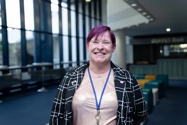 a person with a lanyard around their neck for how to wear a lanyard