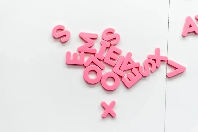 pink magnetic letters on a white surface for how are magnets made