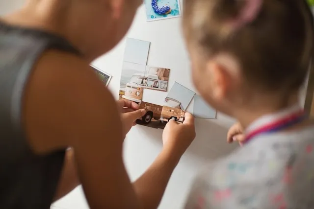 children playing with photo magnets on a fridge for how to make photo magnets
