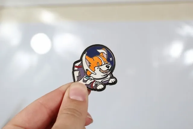 someone holding a custom lapel pin for lapel pin placement