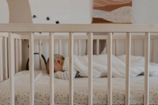 a baby sleeping in a crib for when can babies sleep with a blanket a baby sleeping in a crib for when can babies sleep with a blanket