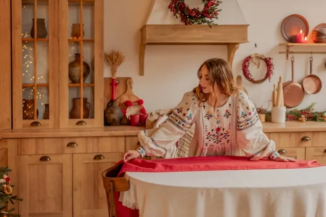 a person setting a table for how to make a tablecloth