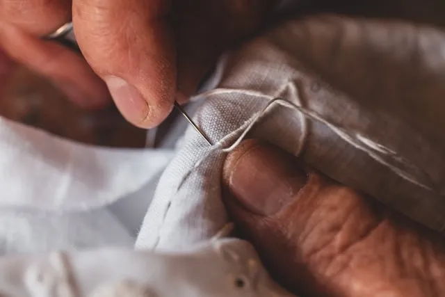 close-up of hand sewing for blanket stitch by hand close-up of hand sewing for blanket stitch by hand
