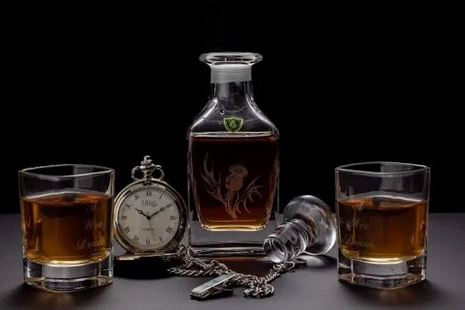 Curated whiskey gift set with a crystal decanter, two filled tumblers, and a vintage pocket watch Curated whiskey gift set with a crystal decanter, two filled tumblers, and a vintage pocket watch