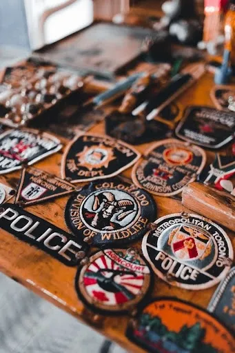 A set of finished iron-on and sew-on DIY embroidered patches arranged on a wooden table A set of finished iron-on and sew-on DIY embroidered patches arranged on a wooden table
