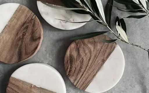 A stack of finished sublimated coasters in wood and marble shown as the end result of how to sublimate a coaster A stack of finished sublimated coasters in wood and marble shown as the end result of how to sublimate a coaster
