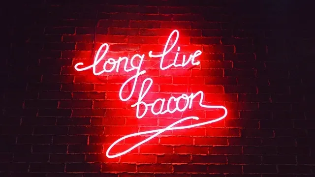 A neon sign mounted securely on an interior wall