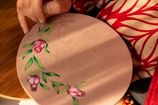 Hand painting a floral design on a round wooden coaster with acrylic paint and a fine brush.jpg Hand painting a floral design on a round wooden coaster with acrylic paint and a fine brush.jpg