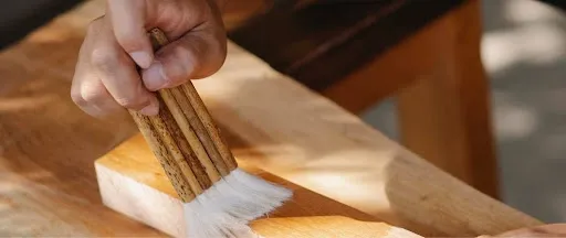 Brushing clear waterproof sealer onto a wood surface, illustrating the technique for sealing and waterproofing a DIY ceramic tile coaster.jpg Brushing clear waterproof sealer onto a wood surface, illustrating the technique for sealing and waterproofing a DIY ceramic tile coaster.jpg