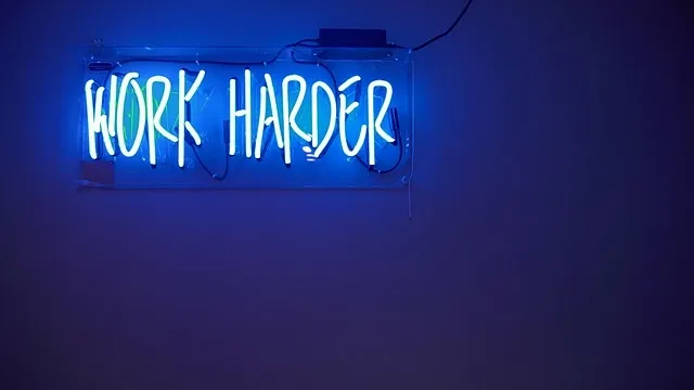 An electric blue neon sign glowing against a dark wall