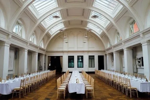 Long rectangular banquet tables dressed with white tablecloths at different drop lengths for a formal event.jpg Long rectangular banquet tables dressed with white tablecloths at different drop lengths for a formal event.jpg