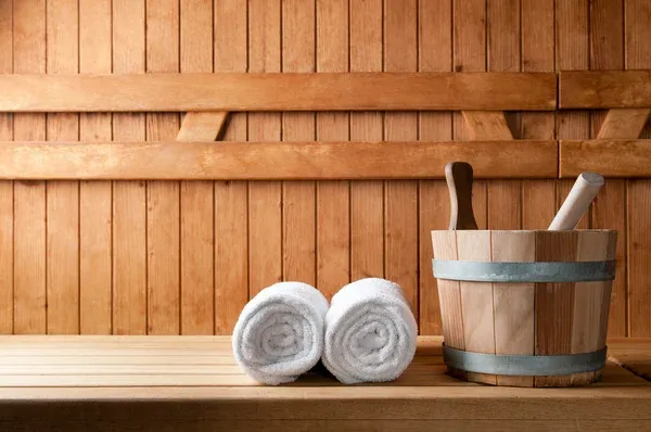White towels next to wooden bucket White towels next to wooden bucket