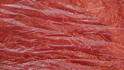 Close-up of a crumpled red plastic tablecloth sheet, the glossy material commonly used for DIY photo backdrops and party decorations.jpg Close-up of a crumpled red plastic tablecloth sheet, the glossy material commonly used for DIY photo backdrops and party decorations.jpg