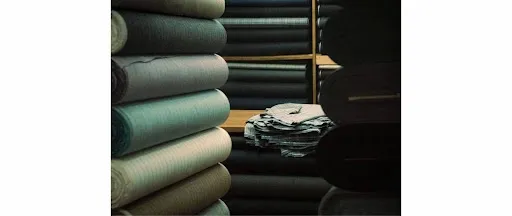 Rolled fabric bolts including satin and polyester textiles stacked on warehouse shelves for tablecloth swag storage between events.jpg Rolled fabric bolts including satin and polyester textiles stacked on warehouse shelves for tablecloth swag storage between events.jpg
