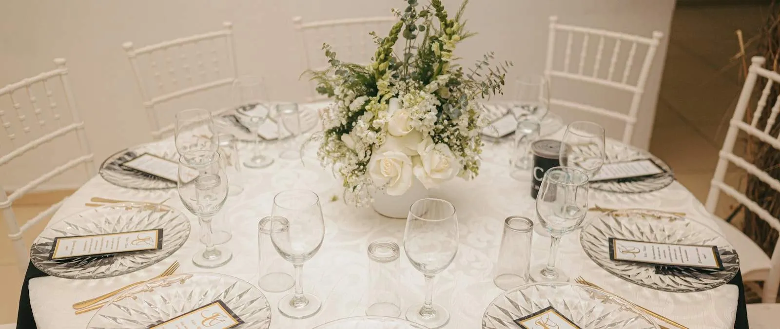 Elegant wedding reception round table with ivory tablecloth, gold candlesticks, and white floral centerpiece-large.jpg Elegant wedding reception round table with ivory tablecloth, gold candlesticks, and white floral centerpiece-large.jpg