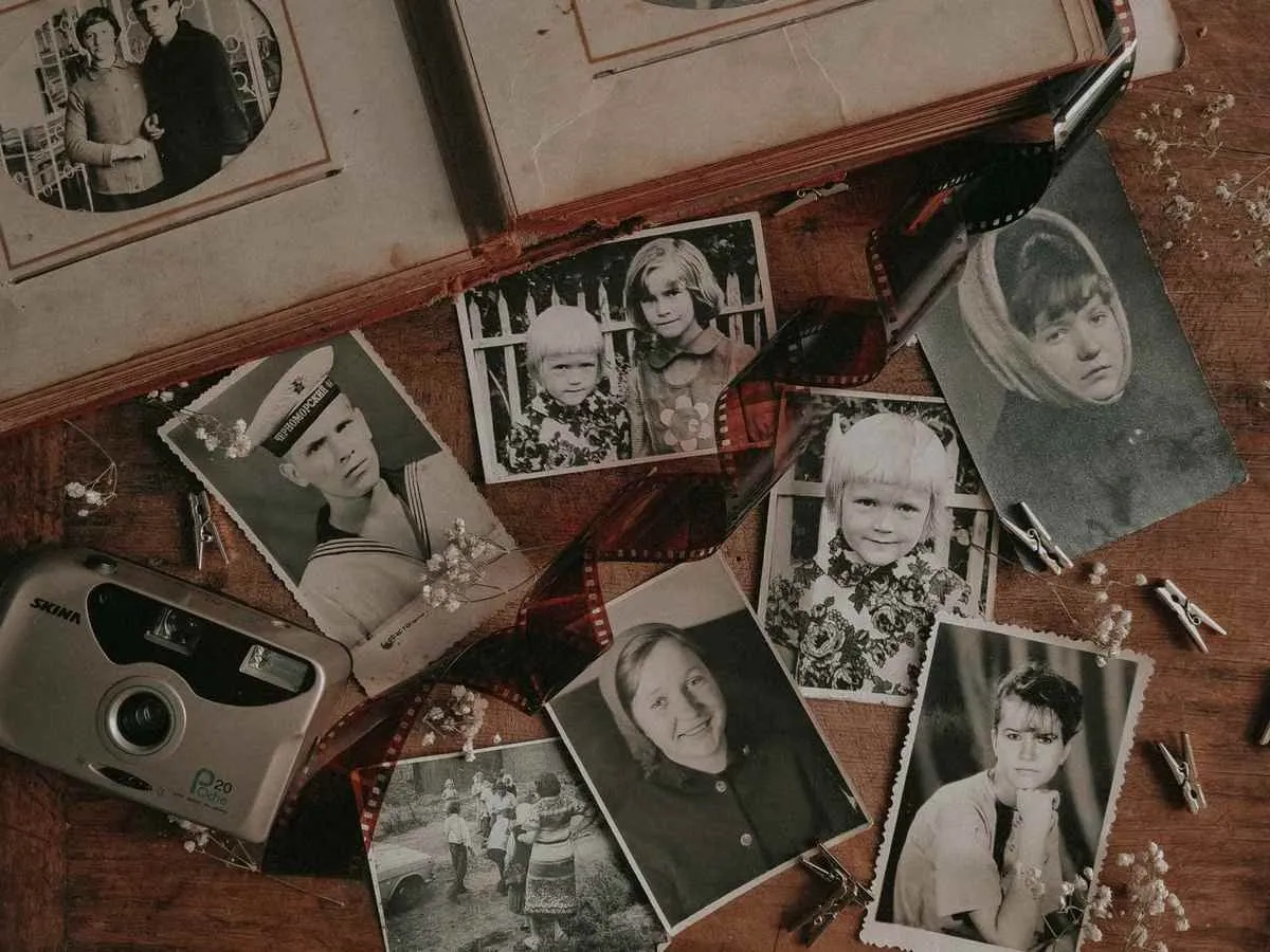 Vintage black and white family photographs spread on a table, the raw material for a 50th birthday photo coaster or memory book Vintage black and white family photographs spread on a table, the raw material for a 50th birthday photo coaster or memory book