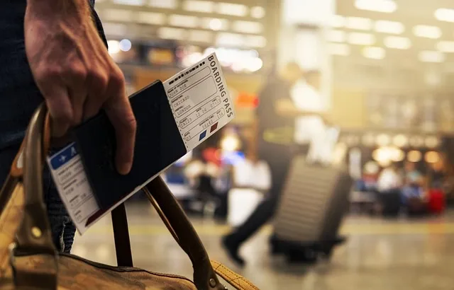 traveler waiting beside suitcase in airport terminal traveler waiting beside suitcase in airport terminal