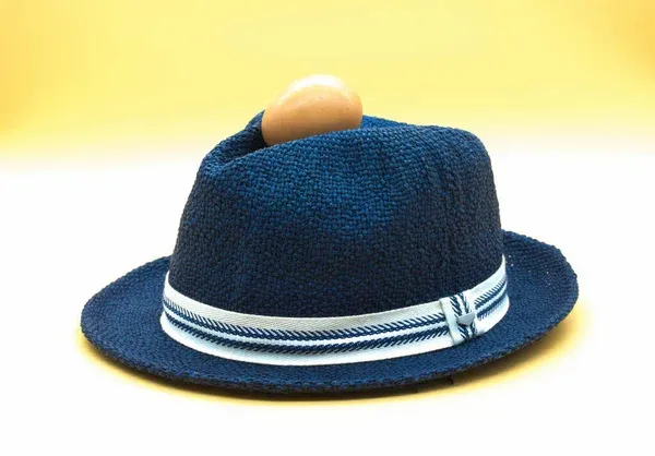 Blue straw hat with an egg on top Blue straw hat with an egg on top