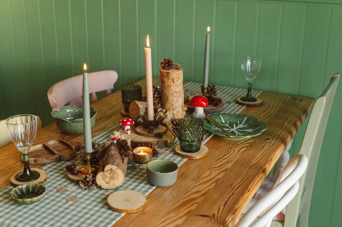 Festive Christmas table with coasters, candles and greenery showing how coaster designs tie into holiday decor Festive Christmas table with coasters, candles and greenery showing how coaster designs tie into holiday decor