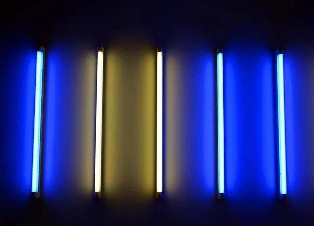 blue and yellow illuminated light tubes on dark background blue and yellow illuminated light tubes on dark background