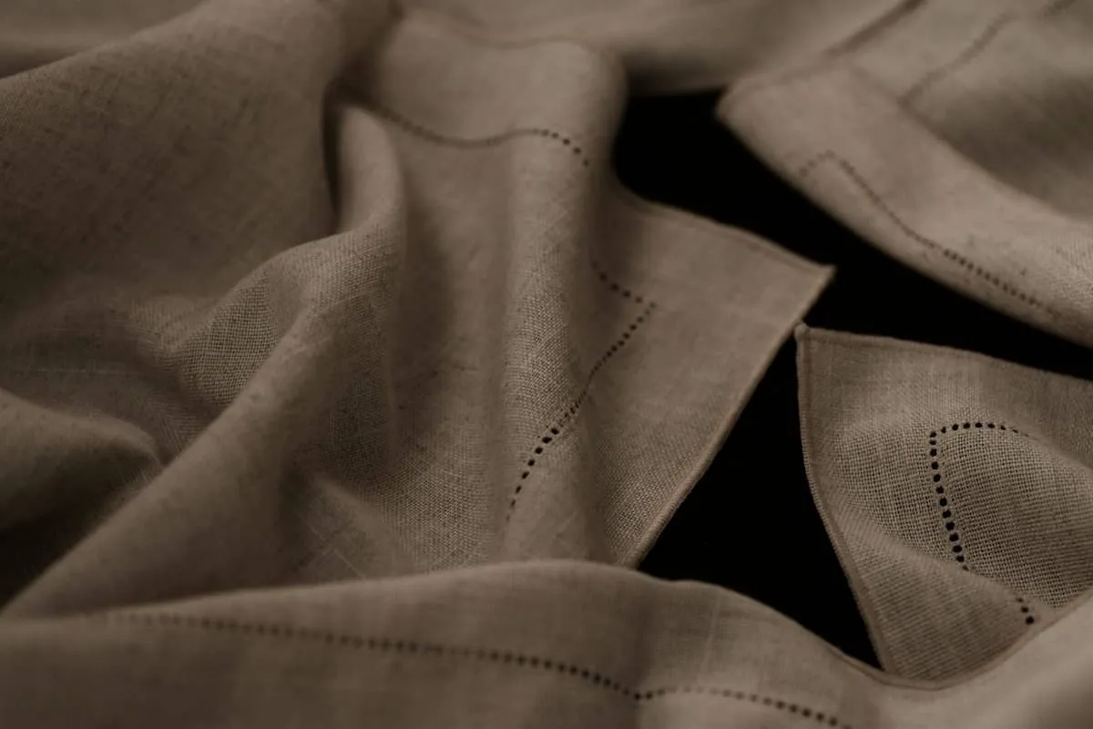 Soft natural linen cloth with a hemstitched edge, the kind of old tablecloth that can be cut into napkins and tea towels.jpg