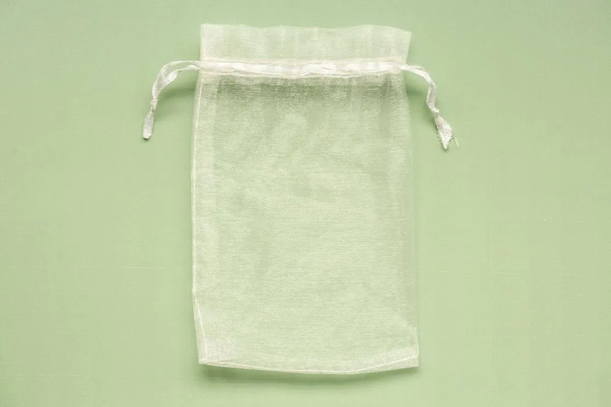 Small drawstring gift bag made from light fabric, a simple way to reuse leftover tablecloth scraps.jpg