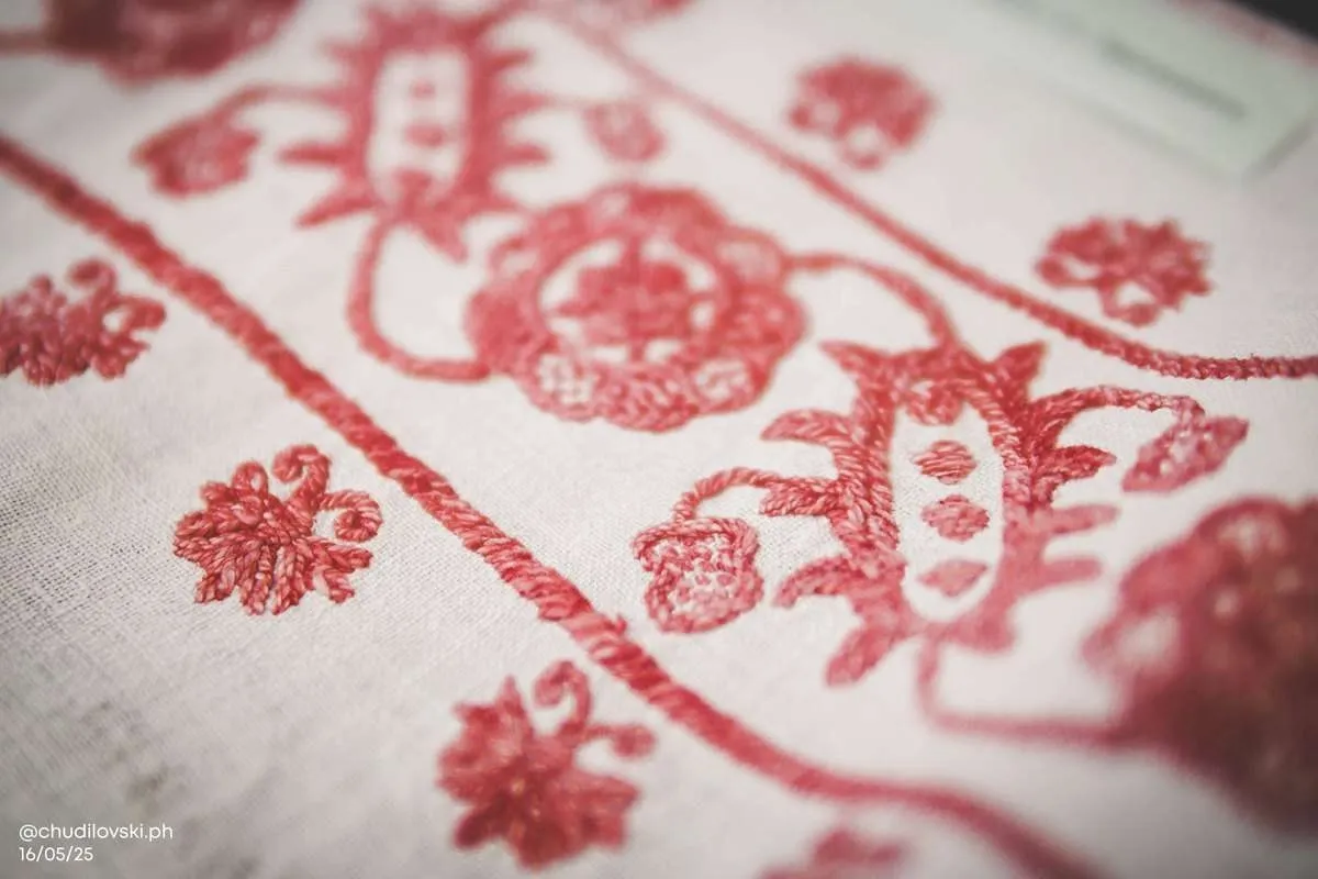 Red embroidered floral motif on white vintage linen, a section worth framing as wall art.jpg
