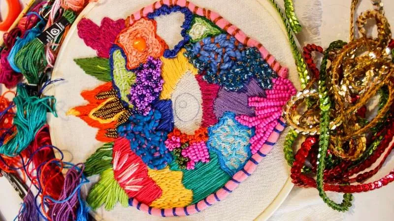Handmade embroidered custom patch with vivid colored threads and beads showing finished-patch construction.jpg
