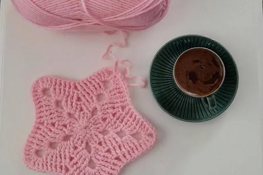 Pink cotton yarn beside a hand-crocheted star doily and a coffee cup on a white surface, showing a star coaster crochet pattern worked in worsted cotton.jpg Pink cotton yarn beside a hand-crocheted star doily and a coffee cup on a white surface, showing a star coaster crochet pattern worked in worsted cotton.jpg