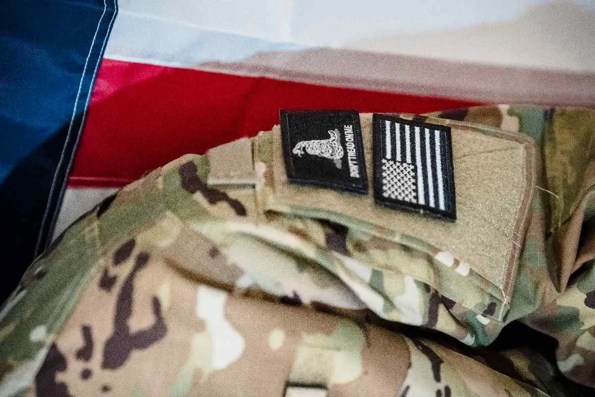 Camouflage tactical uniform with hook-and-loop Velcro patches attached to the sleeve loop panel.jpg