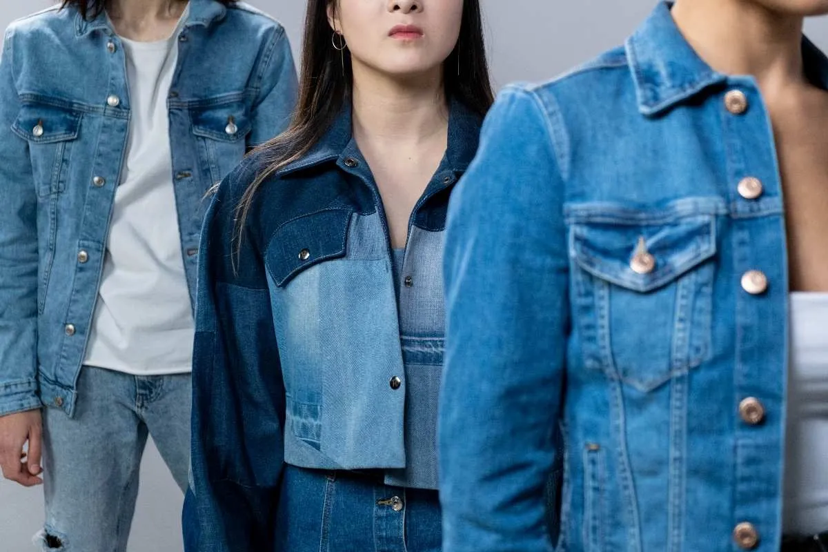 Close-up of denim jacket cuff and pocket details showing high-friction zones where patches tend to lift
