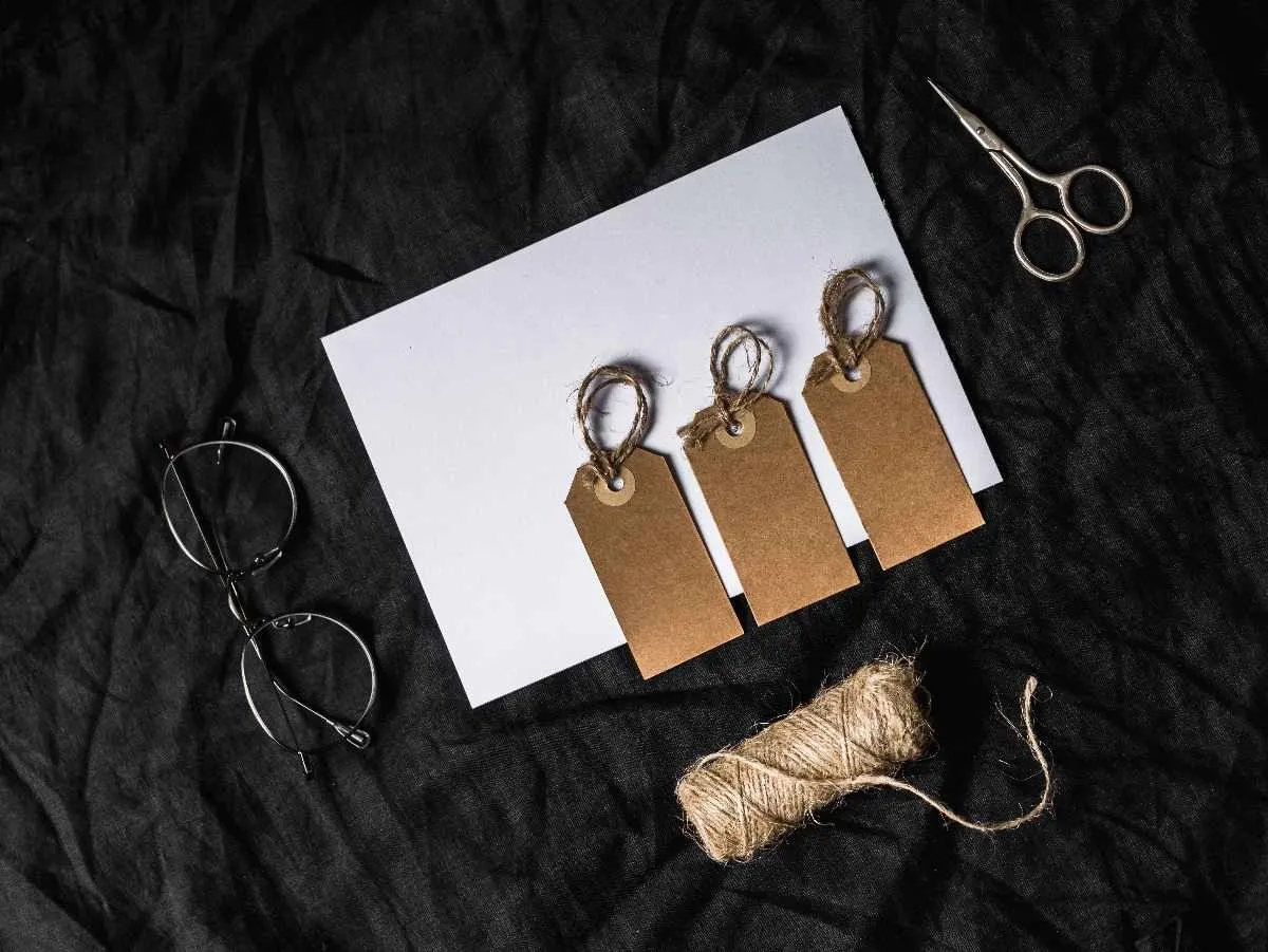 Craft workspace with scissors, tags, and cutting tools used to make custom patches from vinyl and fabric.jpg