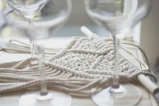 Close-up of stemmed wine glasses on a table showing the glass foot area that a quilted wine glass coaster slipper must fit at a tasting or dinner.jpg